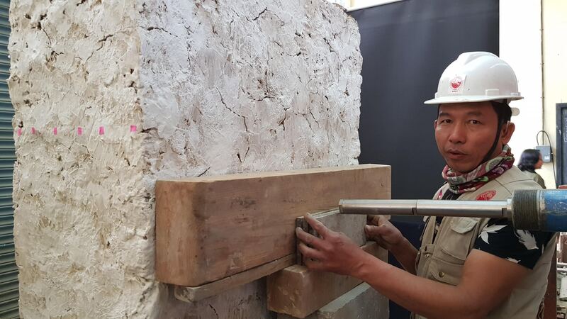 Engineer from NSET (National Society Earthquake Technology Nepal) tests a masonry structure
